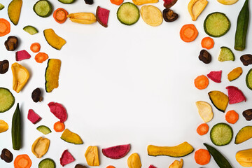 Colorful vegetable chips on white background.