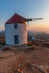 scenic golden hour view of a traditional wind mill in Chora Amorgos  Greece