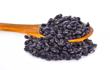 black beans in wood spoon on white background