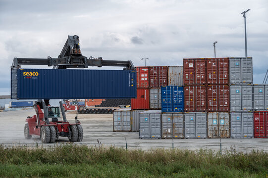 Sassnitz-Mukran, Germany, August 20, 2020: Shunting vehicle is moving a heavy container in the industrial cargo port of Sassnitz Mukran on the island of Rugen in the Baltic Sea, copy space