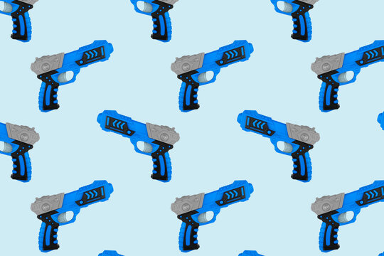 Toys seamless pattern. Plastic toy gun isolated on blue background.