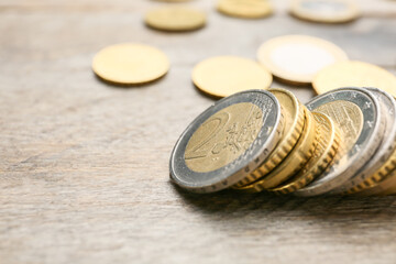 Golden coins on wooden table