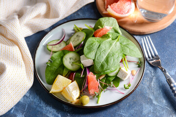 Plate with delicious salad on color background