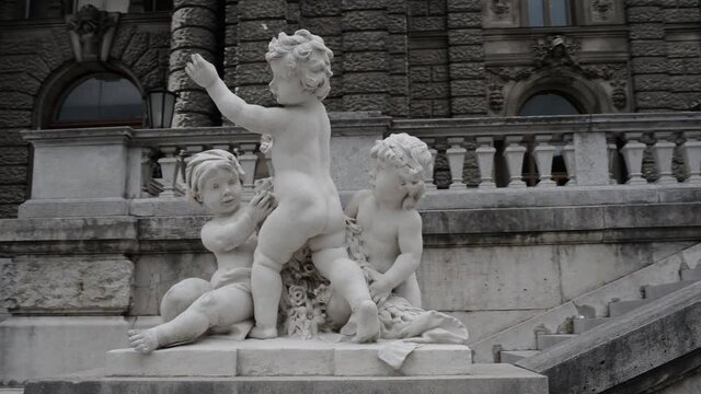 Statue on front of the Habsburg palace complex with ornate, baroque interiors,
