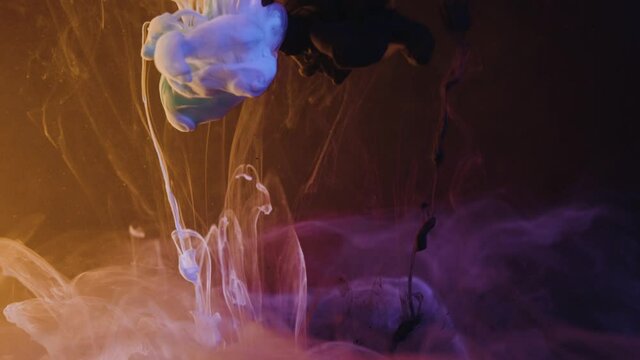 Super slow motion of paint ink transform to colorful magic nebula in front of black background