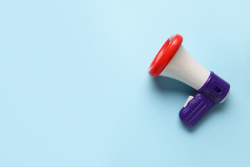 Toy megaphone on blue background