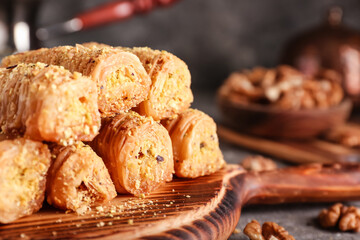 Delicious baklava on wooden board, closeup