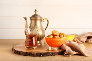 Tasty Turkish tea with delicious baklava on light background