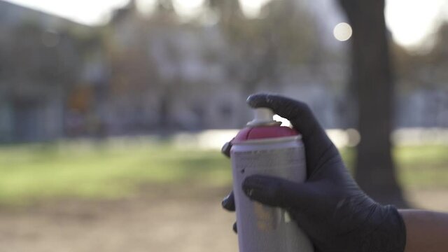 Slow motion shot of person spraying red spray paint into air - Environmental Pollution of earth - Toxic gases in nature