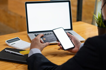 Businessman using laptop with white screen to register with credit card to shop online and shopping online with credit card. home online shopping ideas