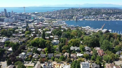 Cinematic 4K bird's-eye drone shot of downtown Seattle, Uptown, Belltown, Danny Triangle, Seattle Center, Space Needle, Elliott Bay with high-rise office and residential buildings in Seattle