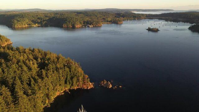 Cinematic 4K drone footage of Orcas Island, sailboats and yachts anchored in Blind Bay on Shaw Island in the San Juan Islands in Washington