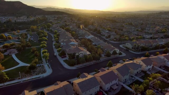 Aerial: Santa Clarita city suburb at sunset, California housing in USA
