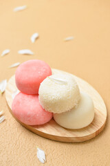 Board with tasty Japanese mochi on color background