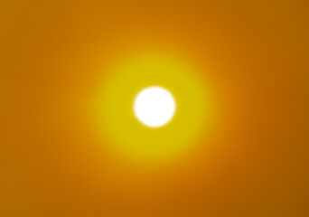 The sun in the sky in the smoke from the fire.