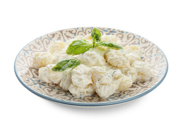 Plate of delicious gnocchi with creamy sauce on white background