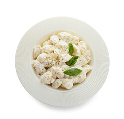 Plate of delicious gnocchi with creamy sauce on white background
