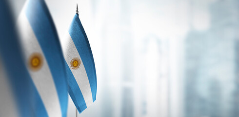 Small flags of Argentina on a blurry background of the city