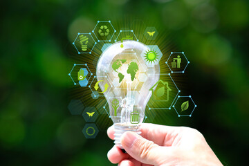 Energy saving light bulb and save world concept, sustainable development. Ecology concept, Green...