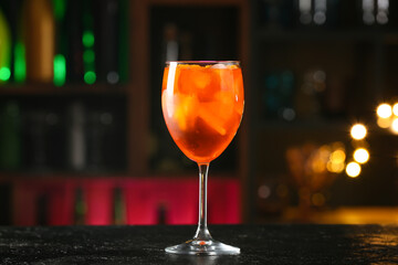 Glass of tasty aperol spritz cocktail on table