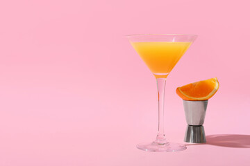 Glass of orange gin and tonic on color background
