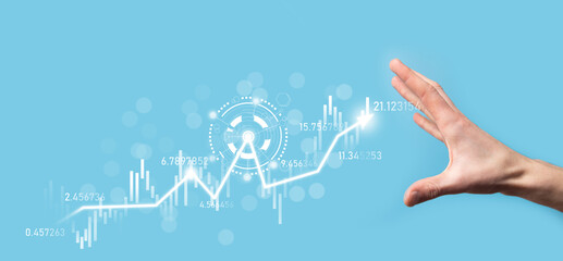 Businessman in hand hold banking business finance graph and invest in stock market investment point,economic growth and investor concept.analysis virtual stock market chart,analyze by use technology