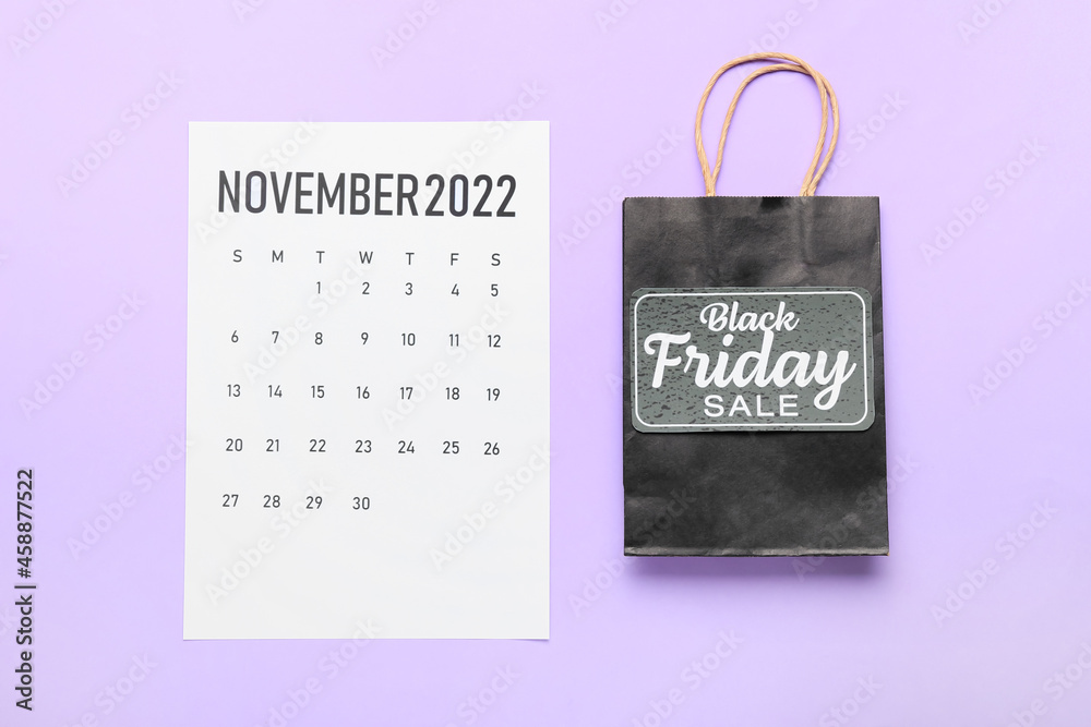 Poster calendar page of november 2022 and shopping bag on color background. black friday