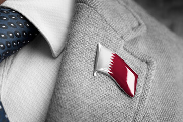 Metal badge with the flag of Qatar on a suit lapel