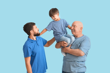 Happy man, his little son and father on color background