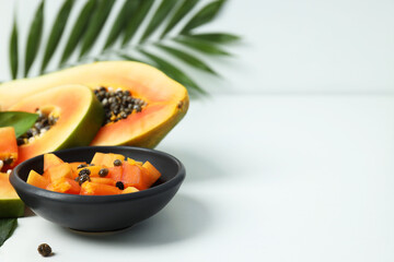 Fresh ripe papaya on white table, space for text