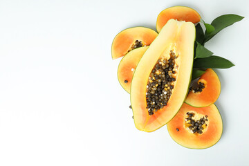 Fresh ripe papaya with leaves on white background