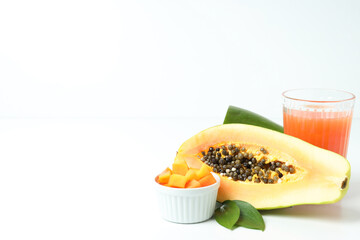 Fresh ripe papaya and juice on white background