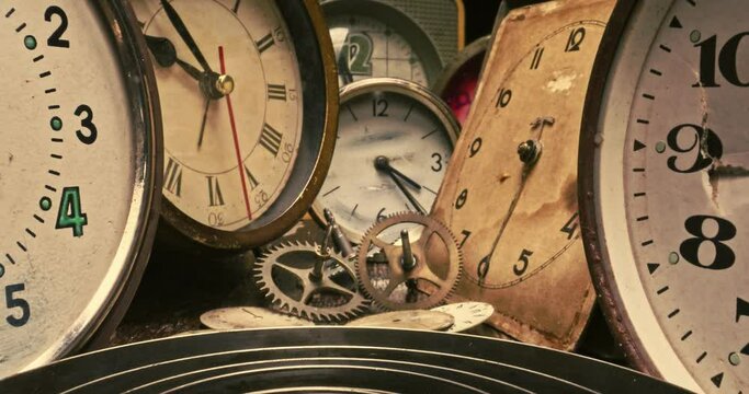 Ruined clocks with watchmakers workshop. Watchmakers workshop with spare parts.
