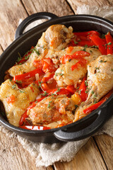 Basque Style Chicken with Peppers  close up in the pan on the table. Vertical