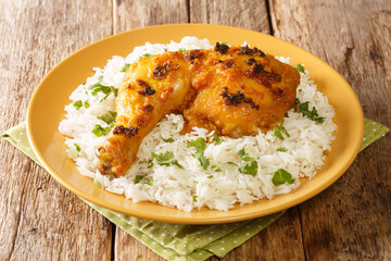 Roasted Spiced Chicken with Coconut Milk Ayam Percik with rice close up in the plate on the table. Horizontal