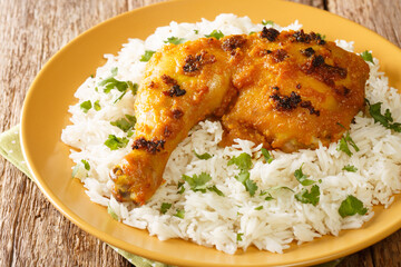Roasted Spiced Ayam Percik chicken with rice close up in the plate on the table. Horizontal