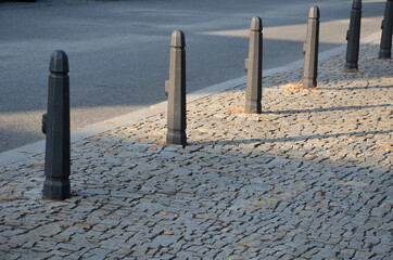 Gray metal bollards are used to protect pedestrians in the pedestrian zone or in the park on the...