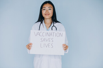 Woman doctor holding sign that vaccination saves lives