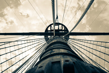 Galleon mast pointing the sky. Antique rigging. Ocean sailing.