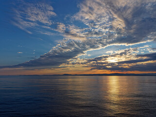 A Weather front moving across the clear Dawn sky on Norways West Coast as a Vessel heads into Port...