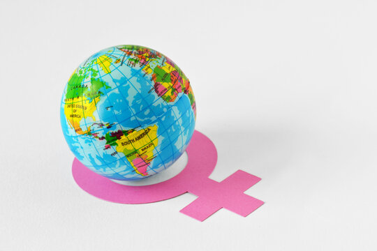 Earth globe inside the circle of female gender symbol - Concept of feminism and gender issues - Powered by Adobe
