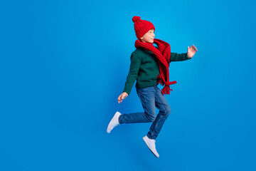 Naklejka na ściany i meble Full length body size photo boy jumping up looking copyspace isolated bright blue color background