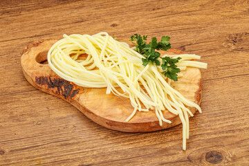 Chechil spaghetti cheese over board