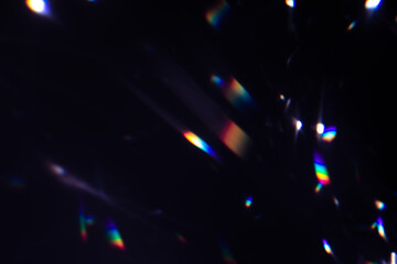 Blur colorful warm rainbow crystal light leaks on black background. Defocused abstract retro film analog effect for using over photos as overlay or screen filter