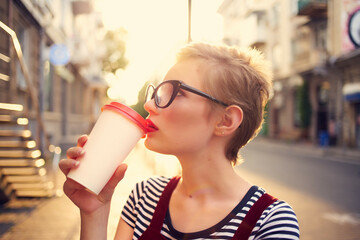 short haired woman outdoors cup with drink walk summer