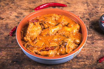 Hungarian chicken stew with paprika and sour cream - chicken paprikash in a bowl, close-up.