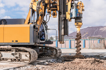 Powerful hydraulic drilling rig on a construction site. Installation of bored piles by drilling....