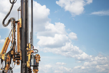 Powerful hydraulic drilling rig on a construction site. Installation of bored piles by drilling. Pile foundations. Drilling in the ground.