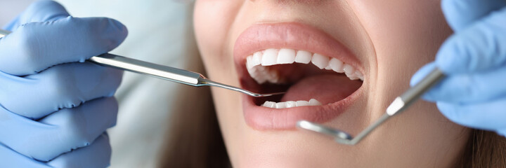 Fototapeta premium Dentist conducts medical examination of patient teeth