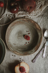 peach pit and peppercorns on a brown plate